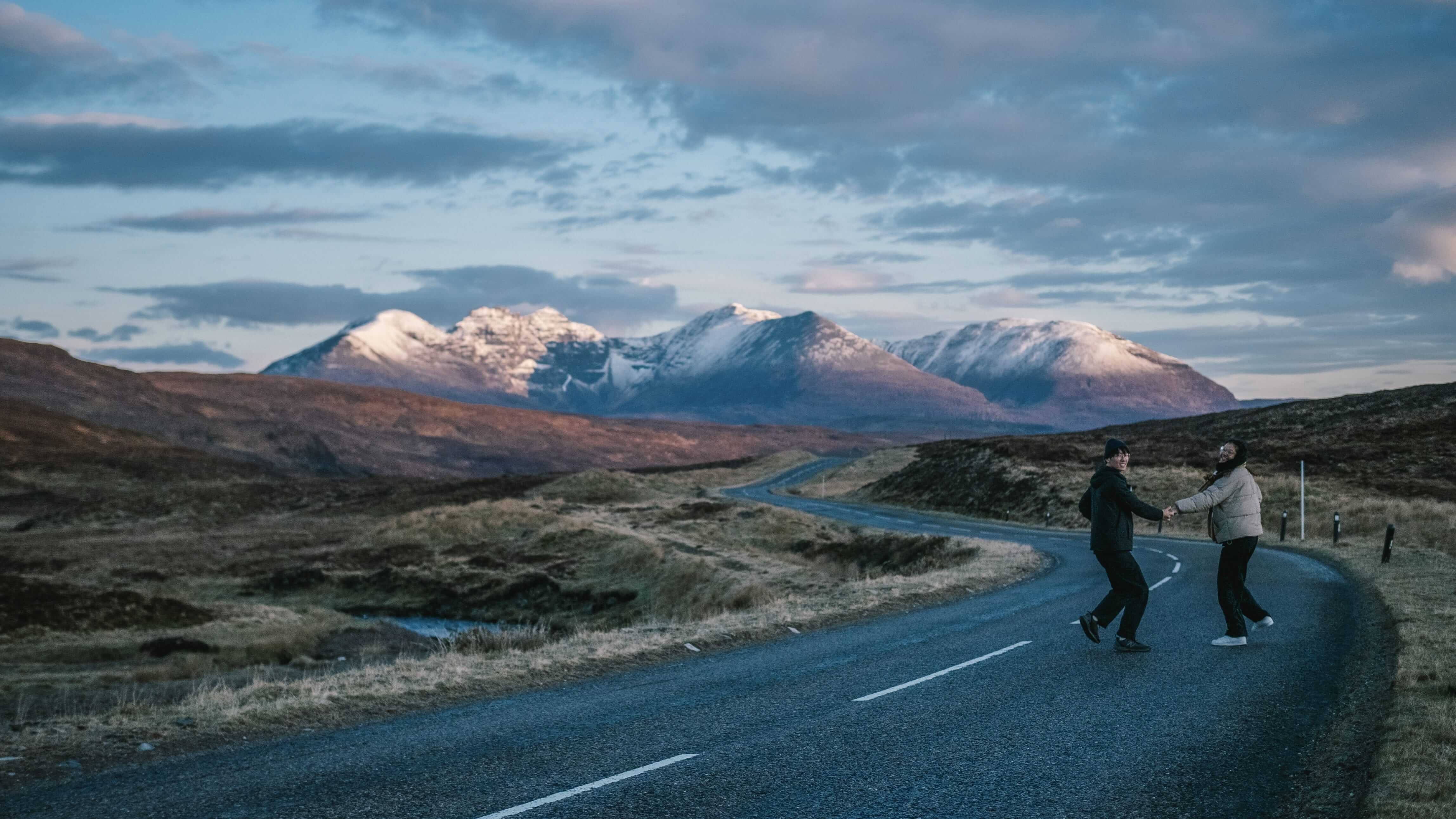 NC500 road with snowcapped mountains in background